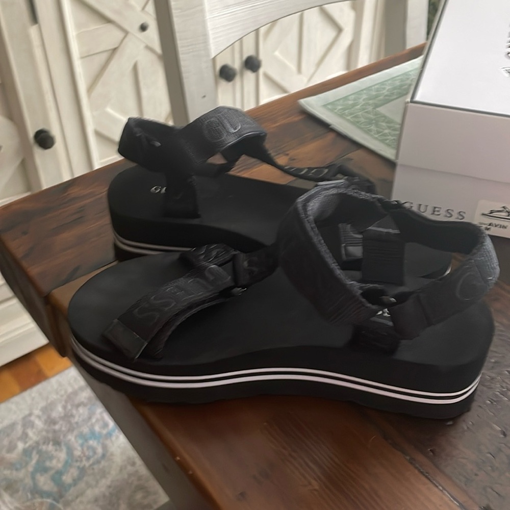 Guess woman’s Alvin platform black fabric sandal.